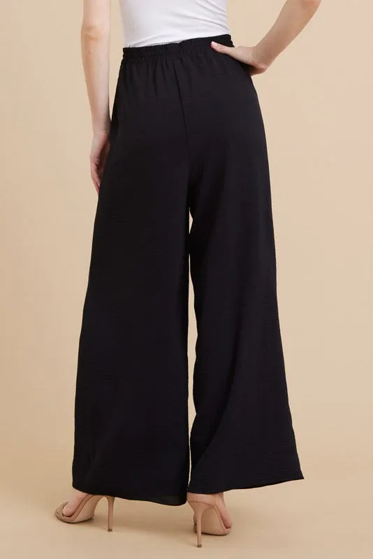 PLEATS FLARED PANTS