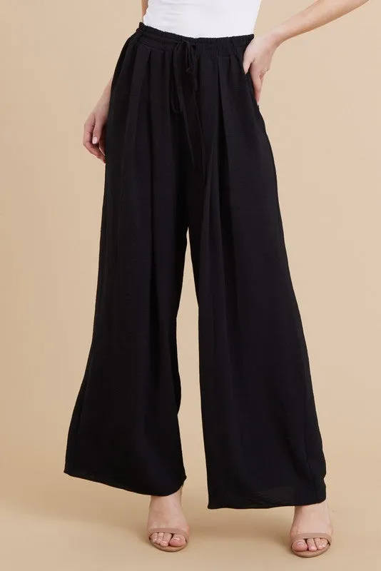 PLEATS FLARED PANTS
